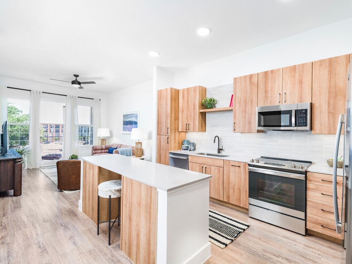 Elevate your culinary experience with Modera Trinity's premium homes. From expansive kitchen islands to built-in dry bars, front-control ranges, and discreetly hidden dishwashers, every detail caters to your modern lifestyle and culinary aspirations. - Modera Trinity