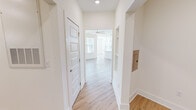 Located at 200 Brooklawn St in Farragut, TN, this well-appointed single-story home offers three bedrooms and three full bathrooms within a thoughtfully designed floor plan. Light-toned luxury vinyl plank flooring flows throughout the main living areas and hallways, lending a clean, cohesive aesthetic throughout. The open-concept kitchen is a standout feature, showcasing a striking two-tone cabinetry scheme with navy blue lower cabinets and crisp white uppers, complemented by a marble-style tile backsplash, white countertops, stainless steel appliances, and a large kitchen island illuminated by pendant lighting. The adjoining dining area transitions seamlessly into the spacious living room, which benefits from abundant natural light through large windows and features a ceiling fan overhead. The primary bedroom suite includes a well-appointed en-suite bathroom with a dual-sink navy blue vanity, white countertops, a tall linen tower cabinet, and direct access to a walk-in closet. Additional bedrooms are carpeted and offer generous closet space. A dedicated laundry room houses a full-size Whirlpool washer and dryer. Throughout the home, crisp white walls, recessed lighting, and consistent finishes create a fresh, modern ambiance ideal for comfortable everyday living.