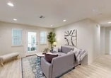 Located at 2531 W Rumble Rd in Modesto, CA, this single-floor residence offers a thoughtfully designed layout with 2 bedrooms, 2 bathrooms, a living room, kitchen, and a dedicated closet. Light wood-look flooring runs throughout, lending a clean, cohesive aesthetic to every room.

The living room is bright and welcoming, featuring recessed lighting, neutral warm-toned walls, and a glass-paneled door flanked by windows that open to a private balcony overlooking the landscaped courtyard below. The outdoor space provides pleasant views of the surrounding multi-story building and greenery.

The kitchen is efficiently designed with crisp white shaker cabinets, granite-look countertops, a center island with bar seating, and a full suite of stainless steel appliances including a refrigerator, range, microwave, and dishwasher — offering ample storage and workspace.

The spacious primary bedroom features multiple windows that allow generous natural light, creating a serene and airy retreat. The second bedroom is cozy and well-lit, with a window and easy access to the hallway. Both bathrooms are finished with white vanity cabinetry, granite-look countertops, and consistent light flooring. The overall ambiance of the residence is modern, clean, and move-in ready.