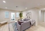 Located at 2531 W Rumble Rd in Modesto, CA, this single-floor residence offers a thoughtfully designed layout with 2 bedrooms, 2 bathrooms, a living room, kitchen, and a dedicated closet. Light wood-look flooring runs throughout, lending a clean, cohesive aesthetic to every room.

The living room is bright and welcoming, featuring recessed lighting, neutral warm-toned walls, and a glass-paneled door flanked by windows that open to a private balcony overlooking the landscaped courtyard below. The outdoor space provides pleasant views of the surrounding multi-story building and greenery.

The kitchen is efficiently designed with crisp white shaker cabinets, granite-look countertops, a center island with bar seating, and a full suite of stainless steel appliances including a refrigerator, range, microwave, and dishwasher — offering ample storage and workspace.

The spacious primary bedroom features multiple windows that allow generous natural light, creating a serene and airy retreat. The second bedroom is cozy and well-lit, with a window and easy access to the hallway. Both bathrooms are finished with white vanity cabinetry, granite-look countertops, and consistent light flooring. The overall ambiance of the residence is modern, clean, and move-in ready.