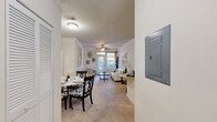 This single-floor, 3-bedroom, 3-bathroom residence at Harrison Creek in Petersburg, Virginia, offers a thoughtfully designed layout that balances comfort and functionality. The open-concept living, dining, and kitchen area serves as the heart of the home, with crown molding, plush carpeting, and abundant natural light streaming through large windows. A ceiling fan adds a practical touch to the living room, which flows seamlessly into the dining area. The kitchen features warm wood cabinetry, granite countertops, black appliances, and a curved breakfast bar with seating — ideal for casual dining and entertaining. Each of the three bedrooms is carpeted and includes ceiling fans, with the spacious primary bedroom benefiting from a walk-in closet. The five total closets throughout the unit provide exceptional storage. All three bathrooms feature wood-style flooring, vanities with granite countertops, and tub-shower combinations. A dedicated laundry area and a central hallway connect the rooms efficiently. The neutral color palette and crown molding details throughout lend the space a clean, cohesive aesthetic well-suited for a variety of lifestyles.