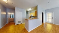 Located at 6720 S Lois Ave in Tampa, Florida, this single-story residence offers a well-organized and functional layout throughout. The open-concept living and dining area is a standout feature, finished with warm hardwood-style flooring and tile accents near the entryway. A ceiling fan overhead and multiple windows allow natural light to fill the space, creating a bright and welcoming atmosphere.

The kitchen is designed for practicality, featuring light wood cabinetry, laminate countertops, and a full suite of white appliances including a range, microwave, and dishwasher. A peninsula with a wood-toned counter edge connects the kitchen to the living area, providing additional workspace and a casual dining option. Tile flooring runs throughout the kitchen for easy maintenance.

The bedrooms are carpeted for comfort and include ceiling fans and closet storage. Each room is finished in a soft gray palette that lends a calm, neutral ambiance. Two full bathrooms serve the home, each equipped with a tub-shower combination, a single vanity with a wood-toned cabinet base, and tile flooring.

Throughout the residence, consistent gray wall tones, white trim, and a mix of hardwood-style and tile flooring unify the overall aesthetic, making this a clean and move-in ready home.