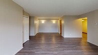 Located at 32450 Cromwell Dr in Solon, OH, this one-bedroom, one-bathroom unit offers a well-organized single-floor layout with a thoughtful mix of functional spaces. The living room is generously sized, featuring durable hardwood-style flooring, neutral-toned walls, and a sliding glass door that opens to a private balcony, filling the space with natural light and outdoor views. Adjacent to the living room, the combined dining and kitchen area features a galley-style kitchen outfitted with warm oak cabinetry, white countertops, a gas range, refrigerator, dishwasher, and overhead microwave — providing efficient workspace and ample storage. The dining area includes hardwood-style flooring and overhead lighting. The bedroom is a comfortable retreat with plush carpet flooring, a large window dressed with vertical blinds for natural light control, and two generously sized closets offering excellent storage capacity. A hallway connects the main living spaces to the bedroom and bathroom, with additional closets tucked throughout. The full bathroom features a tub/shower combination with white tile surround, wood-toned vanity cabinetry, a white countertop, and hardwood-style flooring, maintaining a clean and practical aesthetic throughout.