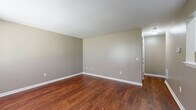 Located on E Oxford Circle in Wichita, Kansas, this single-floor, one-bedroom, one-bathroom unit offers a practical and well-organized layout across a compact but efficiently utilized footprint. The space is finished with neutral taupe-toned walls throughout, creating a consistent and calming aesthetic from room to room.

The spacious bedroom features plush wall-to-wall carpeting that adds warmth underfoot, along with a window fitted with blinds that allows natural light to filter in while maintaining privacy. A dedicated closet provides convenient storage directly off the bedroom.

The common living area showcases rich, warm-toned hardwood-style flooring, offering a durable and visually appealing contrast to the carpeted bedroom. The open wall space and multiple electrical outlets throughout provide flexibility for furniture arrangement.

The bathroom is clean and functional, equipped with a full-sized tub and shower combination featuring white surround panels and chrome fixtures, a toilet, and a vanity. The hardwood-style flooring continues into the bathroom, tying the space together cohesively.

A utility room rounds out the layout, adding practical functionality for storage or laundry needs. Overall, this unit offers a straightforward, move-in-ready design with consistent finishes throughout, well-suited for those seeking a manageable, low-maintenance living space in Wichita.