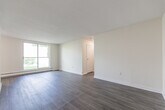 Located at 859 James Street in Woodstock, Ontario, this single-floor unit offers a well-organized and functional layout finished with clean, modern materials throughout. Light wood laminate flooring flows consistently across all areas of the unit, creating a warm and cohesive atmosphere complemented by crisp white walls and white baseboards.

The living area is generously proportioned and bathed in natural light, thanks to a large sliding window that frames an outdoor view of the surrounding greenery. A baseboard heating unit runs along the exterior wall, ensuring comfortable year-round living. The open feel of this space makes it highly versatile for a variety of furniture arrangements.

The bedroom is a well-sized private retreat, also featuring a window with an outdoor view and baseboard heating. It includes direct access to a dedicated closet with a built-in shelf, offering practical and organized storage. Recessed and flush-mount ceiling lights provide consistent illumination throughout the unit.

A connecting hallway efficiently links the key areas of the unit and provides access to additional built-in shelving within a separate closet space — ideal for linen or household storage. The overall design is clean, neutral, and move-in ready, making this unit a practical and comfortable option in the heart of Woodstock.