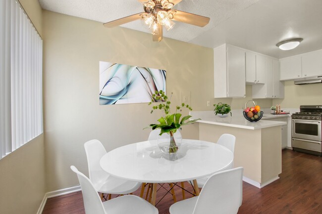 Dining area with ceiliing fan and kitchen on the right - Seville Townhouse