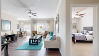 Located at 600 Crowne Commerce Ct in Ormond Beach, FL, this well-appointed single-floor residence offers two bedrooms and three bathrooms within a thoughtfully designed layout. The open living area features rich hardwood-style flooring, crown molding, and a ceiling fan, creating a warm and inviting atmosphere. Large windows dressed with decorative valances allow generous natural light to fill the space throughout the day.

The dining room is a bright, elegant space with dual windows, wainscoting, and hardwood-style floors, providing a comfortable setting for everyday meals. The kitchen is equipped with white cabinetry, black appliances including a gas range, built-in microwave, dishwasher, and refrigerator, all complemented by hardwood-style flooring and ample counter space.

The primary bedroom offers plush carpeting, a ceiling fan, and a well-sized closet, while its en-suite bathroom features a dual-sink vanity with white cabinetry and a full tub-shower combination with classic white tile accents. The second bedroom also features carpeted flooring, a ceiling fan, and a bright window. Two additional closets provide practical storage throughout the home. The hallway connects all rooms efficiently, contributing to a smooth and functional floor plan.