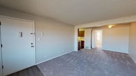 Located at Terra Trace in Evansville, Indiana, this single-floor unit presents a functional and well-organized layout suited for comfortable everyday living. The living area is generously sized, featuring neutral-toned carpet, a textured ceiling, and a ceiling fan that promotes air circulation. The space flows openly toward the kitchen and additional rooms, creating a connected and practical floor plan.

The galley-style kitchen is efficiently designed with warm wood cabinetry lining both walls, light-toned laminate countertops, a double basin sink, and hardwood-style flooring. It comes equipped with a full suite of appliances, including a coil-top electric range, a refrigerator, and a dishwasher, offering everything needed for daily meal preparation.

The bedrooms are carpeted and well-proportioned, each featuring neutral walls and textured ceilings. One bedroom includes a closet with a rod and shelving, while natural light enters through window blinds, creating a bright and airy atmosphere.

The bathroom is finished with a wood-toned vanity, a mirrored medicine cabinet with overhead lighting, a countertop sink, and hardwood-style flooring, providing a clean and practical space. Throughout the unit, consistent neutral tones and practical finishes contribute to a cohesive and inviting ambiance.