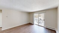 Located at 16 Bailey Ct in Canton, MA, this 2-bedroom, 1-bathroom residence offers a thoughtfully arranged single-floor layout that maximizes functionality and comfort. Hardwood-style flooring runs throughout, lending a clean, cohesive look across all rooms.

The living room is a bright, open space highlighted by a sliding glass door that opens to a private balcony with outdoor views — an ideal spot for natural light and fresh air. Baseboard heating is present throughout the home, ensuring consistent warmth. The textured ceiling in the living area adds a subtle architectural detail.

The kitchen is well-appointed with white shaker-style cabinetry, light countertops, and a full suite of stainless steel appliances, including a range, microwave, dishwasher, and refrigerator. Light wood-tone flooring ties the kitchen seamlessly into the rest of the home.

Both bedrooms are generously proportioned, with the primary bedroom offering a spacious footprint, a double sliding-door closet, and ample natural light from multiple windows. The second bedroom also features a closet and connects conveniently to the hallway. A dedicated hallway provides practical flow between all rooms, completing this efficient and well-maintained residence in Canton, MA.
