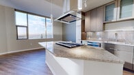 This sleek 870 square foot apartment offers a harmonious blend of style and functionality in the heart of Seattle. The space boasts two bedrooms, including a spacious 250 square foot primary bedroom, and two well-appointed bathrooms. The open-concept layout maximizes the use of space, creating a seamless flow between the living areas.

The kitchen is a highlight, featuring modern cabinetry, high-end appliances, and a central island with pendant lighting, perfect for casual dining or entertaining. Light wood flooring throughout the main living areas adds warmth and complements the neutral color palette.

Floor-to-ceiling windows in the bedrooms and living areas flood the space with natural light and offer breathtaking views of Seattle's iconic skyline and waterfront. The bathrooms are designed with contemporary fixtures, including glass-enclosed showers and sleek vanities.

One of the most striking features is the private balcony, which provides an outdoor extension of the living space and offers panoramic views of the city and surrounding landscape. The apartment's location at 809 S Washington St places residents in the midst of Seattle's vibrant urban scene, with easy access to local amenities and attractions.