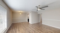 Located at 3620 Burke Rd in Pasadena, TX, this single-story home offers three bedrooms and one bathroom within a practical, well-organized floor plan. Throughout the home, durable wood-look flooring creates a cohesive and easy-to-maintain aesthetic, complemented by neutral warm-gray walls and clean white trim and baseboards.

The living room is an open, welcoming space featuring a ceiling fan with light fixture and a large window dressed with blinds, allowing ample natural light to fill the room. A pendant light near the dining area adds an additional touch of character.

The kitchen is efficiently designed with white shaker-style cabinetry, granite-look countertops, a stainless steel sink with modern brushed-nickel fixtures, and updated hardware throughout, providing functional storage and prep space.

The generously sized primary bedroom includes a ceiling fan, a wide sliding-door closet with a full-width hanging rod, and access to additional rooms. The two secondary bedrooms also feature ceiling fans and wood-look flooring, with one offering a bright window for natural light. A dedicated closet provides additional storage.

The bathroom is clean and straightforward, featuring a full tub-shower combo with white tile surround. The home's compact yet efficient layout makes it a practical and comfortable living space.