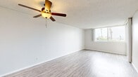 Located at 4200 Harbor Blvd in Oxnard, CA, this one-bedroom, one-bathroom unit offers a generous and well-organized single-floor layout. The expansive living room is a standout feature, characterized by light wood-style laminate flooring, crisp white walls, and a textured ceiling fitted with a ceiling fan — providing both comfort and style. Large windows and a sliding glass door leading to a balcony flood the space with natural light while offering pleasant outdoor views, including glimpses of palm trees and the surrounding neighborhood.

The kitchen connects to the living area via an open pass-through counter, creating an airy, connected feel suited for everyday living and entertaining. Cabinetry is finished in white, maintaining a clean, bright aesthetic throughout.

The bedroom is comfortably sized, continuing the light laminate flooring and neutral palette seen throughout the unit. It connects to a hallway that leads to the full bathroom, which features a white vanity with a stone-finish countertop, a bold-framed mirror, and a tub-shower combination — all finished in a clean, modern style.

The hallway provides functional flow between rooms, tying the layout together seamlessly. Overall, this unit delivers a bright, neutral, and move-in ready environment in a coastal Southern California setting.