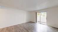 Located at 720 S Conway Rd in Orlando, Florida, this single-floor unit offers a well-organized layout with a thoughtful mix of living, dining, and functional spaces. The living room is bright and open, featuring wood-look vinyl flooring, crisp white walls, a textured ceiling, and a sliding glass door that floods the area with natural light while providing access to an outdoor space with views of the surrounding greenery.

The two dining areas offer flexibility for various furniture arrangements, both finished with the same durable wood-look flooring that continues throughout the main living spaces. The kitchen is well-appointed with white shaker-style cabinetry, light stone countertops, a deep stainless steel sink with a matte black faucet, and stainless steel appliances including a refrigerator and dishwasher. An adjacent pantry provides additional storage convenience.

The bedroom features plush carpeting, a ceiling fan with integrated lighting, natural light from a window with blinds, and a wide sliding-door closet offering generous storage capacity. Two additional closets are available throughout the unit.

The bathroom is clean and functional, featuring wood-look flooring, a tiled tub-shower combo with a curved curtain rod, and a vanity with a stone-look countertop. A utility room and hallway complete the efficient layout of this Orlando residence.