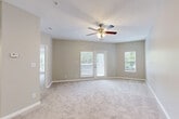 Located at 2400 Whitehall Estates Dr in Charlotte, NC, this well-appointed one-bedroom, one-bathroom residence offers a thoughtfully designed single-floor layout. The open-concept living and dining area is generously sized, featuring plush carpeting, neutral warm-gray walls, a ceiling fan with light fixture, and a glass door that leads to a private balcony with outdoor views — allowing natural light to fill the space. Additional windows further brighten the room.

The kitchen is efficiently laid out with light wood-look flooring, crisp white shaker-style cabinetry, light stone countertops, a classic subway tile backsplash, and a full suite of stainless steel appliances including a refrigerator, electric range, and over-the-range microwave. A pantry closet and sink complete the functional space.

The spacious primary bedroom features soft carpeting, a ceiling fan, and a charming bay window that frames greenery views. It includes direct access to the bathroom and generous closet space. With four closets throughout the unit, storage is plentiful. An in-unit laundry area adds everyday convenience. The overall aesthetic is clean, bright, and move-in ready.
