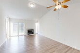 Located at 5350 N Brawley Ave in Fresno, CA, this single-story, 3-bedroom, 2-bathroom home offers a well-designed layout with a clean, modern aesthetic throughout. The open living room serves as the heart of the home, showcasing soaring vaulted ceilings, a ceiling fan, and a tile-surround fireplace as a central focal point. Sliding glass doors flood the space with natural light and open to a private balcony, extending the living area outdoors. Hardwood-style flooring runs throughout the main living areas, adding warmth and continuity.

The galley-style kitchen is efficiently designed with warm wood cabinetry, white countertops, stainless steel appliances including a range, refrigerator, and dishwasher, and a window that brings in additional natural light.

The three bedrooms are carpeted for comfort and feature neutral walls and windows with outdoor views, creating bright and restful retreats. The primary bedroom offers a generous footprint ideal for a full furniture arrangement.

Both bathrooms are thoughtfully appointed with warm wood vanities, white countertops, large mirrors, and tub-shower combinations with hardwood-style flooring. A dedicated closet provides additional storage. The home presents a clean, move-in-ready condition throughout.