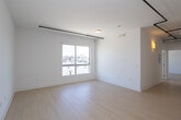 Located at 710 N El Centro Ave in the heart of Hollywood, Los Angeles, this modern single-floor unit offers a clean, contemporary design throughout. Light wood-style flooring flows seamlessly across the open living areas and bedrooms, complementing the crisp white walls that create a bright, airy atmosphere.

The kitchen is thoughtfully designed with flat-front white cabinetry extending to the ceiling, gray quartz countertops, a textured white tile backsplash, and a full suite of stainless steel appliances including a gas range, over-the-range microwave, and French door refrigerator. An in-unit stacked washer and dryer is conveniently tucked into an adjacent closet.

The bedrooms are generously sized, featuring large sliding windows that frame views of the surrounding Hollywood neighborhood, allowing abundant natural light to fill each room. Track lighting adds a modern, versatile touch to the living spaces.

The bathrooms are elegantly finished with warm wood-tone vanities, white countertops, mosaic tile flooring, large mirrors with modern wall sconces, and glass-enclosed showers with marble-style tile surround. The primary bathroom connects directly to a spacious walk-in closet equipped with dual hanging rods and ample shelving, providing exceptional storage. The overall design is clean, minimal, and well-suited for modern urban living.