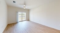 This contemporary 680 square foot apartment in Fort Myers, Florida offers a harmonious blend of style and functionality. The open-concept floor plan seamlessly integrates the living room and kitchen, creating a spacious feel. The kitchen is a highlight, boasting sleek white cabinetry, granite countertops, and stainless steel appliances, including a side-by-side refrigerator and built-in microwave.

The bedroom, measuring 110 square feet, features a large window with blinds, allowing for abundant natural light and privacy control. The bathroom is modern and efficient, with a white subway-tiled shower/tub combination and a curved shower rod for added space.

Throughout the apartment, light-toned wood-look flooring adds warmth and continuity. Large windows in the living area and bedroom not only brighten the space but also offer views of the surrounding area. A sliding glass door leads to a small balcony, perfect for enjoying the Florida weather.

The apartment's neutral color palette and clean lines create a canvas for personal style. Recessed lighting and ceiling fans contribute to the overall modern aesthetic while providing practical illumination and air circulation. This well-designed space offers comfort and style in a compact, efficient layout.
