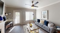 This single-floor residence offers a thoughtfully designed layout that balances comfort and functionality throughout its key living areas. The living room serves as the heart of the home, featuring wood-style flooring, a ceiling fan, and large vertical-blind windows alongside a glass door that floods the space with natural light and provides outdoor access. The galley-style kitchen is equipped with stainless steel appliances — including a refrigerator, range, and microwave — paired with white cabinetry, light stone-finish countertops, a double sink, and durable wood-look flooring, creating a clean and efficient workspace. The primary bedroom is generously proportioned with plush carpeting and a sliding glass door that opens to the exterior, offering additional natural light and outdoor views. It connects to a private en-suite bathroom featuring a single vanity with a wide mirror and ample under-sink storage. A second bedroom provides comfortable accommodations with soft carpeting, natural light from large windows, and a sliding closet for convenient storage. The second full bathroom mirrors the clean aesthetic of the home, featuring wood-style flooring, a single-sink vanity, and bright window light. Neutral tones and consistent finishes throughout create a cohesive and inviting ambiance.