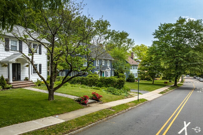 A row of homes in Maplewood, NJ, on a tree-lined residential street.