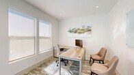 Located at 1250 Marden Rd in Apopka, Florida, this single-floor professional office suite offers a compact yet efficiently designed workspace spread across six individual rooms. The layout centers around a bright, well-appointed corridor flanked on both sides by glass-walled offices and meeting rooms, creating a sense of openness and transparency while maintaining acoustic privacy. Sleek black-framed glass partitions and white-painted walls contribute to a clean, contemporary aesthetic throughout.

Each office is outfitted with light wood L-shaped desks, ergonomic seating, and recessed lighting that ensures consistent, comfortable illumination. The distinctive patterned carpet — featuring warm earth tones of brown, gold, and muted blue — runs throughout the suite, adding visual texture and a sophisticated design element that ties the spaces together. Several rooms include whiteboard panels, making them well-suited for collaborative meetings or client consultations.

Natural light filters into select offices through frosted windows, complementing the recessed ceiling lights. The overall ambiance is modern and professional, with a neutral color palette that promotes focus and productivity. This thoughtfully designed office suite is ideal for a small professional team or service-oriented business seeking a refined, functional workspace in Apopka.