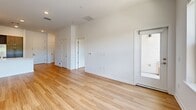 Located at 99 Old Amboy Rd in Old Bridge, NJ, this well-appointed 2-bedroom, 2-bathroom residence offers a thoughtfully designed single-floor layout with a clean, contemporary aesthetic throughout. Light-toned hardwood flooring flows seamlessly across the living areas and bedrooms, creating a warm and cohesive feel.

The open-concept kitchen and living room serve as the heart of the home. The kitchen is outfitted with rich dark-brown cabinetry extending to the ceiling, white quartz countertops, a tile backsplash, stainless steel appliances including a gas range, microwave, and refrigerator, and a peninsula with a built-in sink — ideal for both cooking and entertaining.

Both bedrooms are bright and well-proportioned, benefiting from large windows that invite natural light and offer views of the surrounding greenery. The spacious primary bedroom includes generous closet space with built-in shelving and hanging rods. A second closet provides additional storage.

The two bathrooms are finished in a modern style with warm wood-toned vanities, white countertops, large mirrors, neutral tile flooring, and glass-enclosed showers. Each bathroom maintains a clean, minimalist design in keeping with the overall aesthetic of the residence.