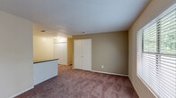 Located at 320 E West Pkwy in Anderson, SC, this two-bedroom, one-bathroom single-story home offers a practical and well-organized layout. The galley-style kitchen is efficiently designed with white cabinetry, dark granite-style countertops, hardwood-style flooring, and includes a full suite of appliances — refrigerator, range, dishwasher, and microwave. An adjacent pantry provides additional storage. The kitchen flows into a separate dining room, creating a natural transition to the carpeted living room, which features a closet and an open feel. Both bedrooms are carpeted and equipped with ceiling fans and dedicated closets. The primary bedroom is generously sized and benefits from natural light through its window, while the second bedroom also enjoys a window with outdoor views of lush greenery. The shared full bathroom includes a tiled tub-shower combination, toilet, and vanity with granite-style countertops. Additional conveniences include a dedicated laundry area, a hallway connecting the main living spaces, and a total of four closets spread throughout, offering excellent storage. Textured ceilings are present throughout the home, and neutral warm-beige wall tones create a cohesive, inviting atmosphere.