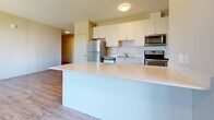 Located at 680 Garibaldi Ave in London, Ontario, this thoughtfully designed 2-bedroom, 1-bathroom unit offers a comfortable and functional layout across a single floor. Light-toned luxury vinyl plank flooring runs throughout the main living areas, complemented by neutral warm-beige walls that create a bright and welcoming atmosphere.

The entrance leads into a well-organized hallway with ample closet storage — four closets in total — providing excellent organization throughout. The open-concept living and dining area is generously sized, filled with natural light from a large picture window with views of the surrounding neighbourhood.

The kitchen is a standout feature, boasting crisp white cabinetry, a subway tile backsplash, a large peninsula with a light countertop ideal for casual dining, and a full suite of stainless steel appliances including a refrigerator, stove, microwave, and dishwasher.

Both bedrooms are carpeted for comfort, each featuring sliding-door closets and windows that invite natural light. The spacious primary bedroom offers room for a full furniture arrangement. The bathroom is finished with a white vanity, light countertop, and a well-lit mirror. A private balcony extends the living space outdoors, offering a pleasant retreat.