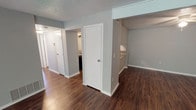 Located at 4223 Lakeshore Dr in Shreveport, Louisiana, this single-floor unit offers a straightforward and functional layout spread across several well-defined spaces. The living area greets you upon entry, featuring rich, dark hardwood-style flooring, a ceiling fan, and a window fitted with blinds that allows for natural light. Textured ceilings are consistent throughout the unit, adding a classic touch to the interior.

The kitchen is equipped with white cabinetry, granite-style countertops, a black refrigerator, and a range, providing ample storage and workspace. A hallway connects the main living areas to the private rooms, where the flooring transitions to wall-to-wall carpet for added comfort.

The bedrooms are generously sized, each featuring windows with blinds that bring in natural light and closet access. The neutral gray walls throughout the unit create a clean, cohesive aesthetic that complements both the hard flooring and carpeted areas.

The bathroom includes a full tub-and-shower combination with white tile surround, chrome fixtures, and hardwood-style flooring, maintaining the unit's consistent design language. Overall, this space presents a practical and well-maintained interior with a neutral palette suited for a variety of living arrangements.