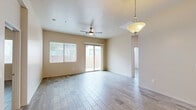 Located at 2121 N Grace Blvd in Chandler, Arizona, this single-story, 3-bedroom, 3-bathroom home offers a well-designed layout with modern finishes throughout. Wood-look tile flooring flows seamlessly across the living areas, bedrooms, and bathrooms, creating a cohesive and easy-to-maintain aesthetic.

The kitchen is a standout feature, equipped with rich dark espresso cabinetry, granite countertops, stainless steel appliances including a refrigerator with ice maker, range, microwave, and dishwasher. A peninsula with a granite overhang provides additional workspace and a casual dining option, while recessed lighting and a pendant light add warmth and functionality.

The spacious primary bedroom includes a ceiling fan, a sliding glass door leading to the outdoor patio, and an en-suite bathroom with a walk-in shower. The additional bedrooms are bright and airy, each featuring multiple windows that invite natural light and offer views of the surrounding neighborhood. Closets with sliding panel doors provide ample storage.

The secondary bathrooms are clean and functional, with one featuring a shower-tub combination. Throughout the home, neutral tones and clean lines contribute to a calm, modern atmosphere. The outdoor area features a gravel-landscaped yard, well-suited for Arizona's climate.