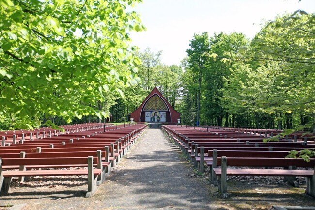 The Sanctuaire de Beauvoir surrounded by a lush landscape
