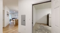 Located at 2967 Route W in Saugerties, NY, this single-floor residence offers a thoughtfully designed, open-concept layout with modern finishes throughout. The interior is characterized by clean white walls, recessed lighting, and light-toned wood-look flooring that flows seamlessly across the main living areas, creating a cohesive and airy atmosphere.

The kitchen serves as a central hub of the home, featuring light wood cabinetry, stainless steel appliances, a white countertop island with pendant lighting overhead, and a built-in dishwasher — ideal for both everyday meals and entertaining. The kitchen opens directly into the living area, which benefits from a sliding glass door that allows natural light to fill the space.

The bedroom is comfortably proportioned and includes closet access, while the bathroom is outfitted with a full soaking tub and shower combination with wood-look flooring. A dedicated utility room houses a stacked washer and dryer alongside the home's mechanical systems, ensuring convenient in-unit laundry. An attached garage with an automatic opener provides enclosed parking and additional storage space, complete with concrete flooring. The electrical panel is accessible from a hallway connecting the main living area to the garage.