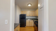 Located at 110 North 17th Street in St. Louis, Missouri, this one-bedroom, one-bathroom unit offers a well-organized layout with consistent hardwood flooring throughout. The living room is a bright, open space anchored by large windows that flood the room with natural light and frame elevated views of the surrounding St. Louis cityscape. Neutral-toned walls and clean white baseboards contribute to a simple, cohesive aesthetic.

The bedroom is a comfortably sized private retreat, also finished with warm hardwood floors and neutral walls. A full-width built-in closet with bifold doors provides generous storage, keeping the room uncluttered and functional.

The bathroom is cleanly finished with tile flooring in an earth tone, a white vanity with cabinet storage, a mirrored medicine cabinet, and a full-sized tub and shower combination. The overall design is practical and tidy.

The kitchen area, visible in the floor plan, is efficiently arranged to make the most of the available space. Throughout the unit, the consistent use of light tones, wood flooring, and white trim creates a unified and inviting atmosphere. The city views accessible from the living areas add a notable sense of openness to this well-appointed St. Louis residence.