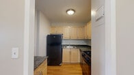 Located at 110 North 17th Street in St. Louis, Missouri, this one-bedroom, one-bathroom unit offers a well-organized layout with consistent hardwood flooring throughout. The living room is a bright, open space anchored by large windows that flood the room with natural light and frame elevated views of the surrounding St. Louis cityscape. Neutral-toned walls and clean white baseboards contribute to a simple, cohesive aesthetic.

The bedroom is a comfortably sized private retreat, also finished with warm hardwood floors and neutral walls. A full-width built-in closet with bifold doors provides generous storage, keeping the room uncluttered and functional.

The bathroom is cleanly finished with tile flooring in an earth tone, a white vanity with cabinet storage, a mirrored medicine cabinet, and a full-sized tub and shower combination. The overall design is practical and tidy.

The kitchen area, visible in the floor plan, is efficiently arranged to make the most of the available space. Throughout the unit, the consistent use of light tones, wood flooring, and white trim creates a unified and inviting atmosphere. The city views accessible from the living areas add a notable sense of openness to this well-appointed St. Louis residence.