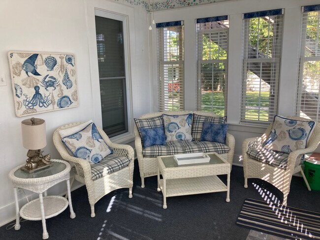 Shared porch-with wicker chairs and loveseat - 317 Eagle St