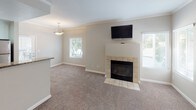 Located at 240 Natoma Station Dr in Folsom, California, this single-floor residence offers a well-organized layout with a comfortable blend of functional design and modern finishes. The open living area serves as the heart of the home, highlighted by a tile-surround fireplace, crown molding, and multiple windows that invite generous natural light. Neutral carpet and soft wall tones create a warm, cohesive ambiance throughout. The galley-style kitchen is thoughtfully appointed with granite countertops, white cabinetry, a double-basin sink, wood-look vinyl flooring, and a full suite of stainless steel appliances, including a refrigerator and range. Ample pantry storage is provided by a set of tall built-in cabinets. The bedrooms are generously proportioned, each featuring plush carpet, neutral walls, and windows with blinds that allow for natural light and outdoor views. Closet space is available, with at least one bedroom offering a sliding closet door. The bathrooms are finished with granite-topped white vanities, wood-look flooring, lighted mirrors, and a clean, functional layout. The overall design emphasizes practicality and comfort, with consistent finishes tying each space together cohesively.