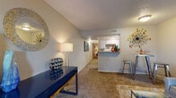 This single-floor residence offers a practical and comfortable layout designed for everyday living. The living area serves as the heart of the home, featuring plush wall-to-wall carpeting, a textured ceiling, and a sliding glass door that invites natural light and provides access to the outdoors. The open flow connects seamlessly to a dedicated dining nook, making the space well-suited for both relaxing and entertaining.

The galley-style kitchen is efficiently arranged with ample white cabinetry, a double-basin sink, laminate countertops, and wood-look flooring. A built-in range, microwave, and refrigerator provide full functionality, while a pass-through counter connects the kitchen to the main living area for easy interaction.

The bedroom is a serene retreat, appointed with soft carpeting, a ceiling fan with integrated lighting, and a window dressed with sheer curtains that filter natural light. The room offers a calm, restful ambiance with neutral wall tones and generous space.

The bathroom is cleanly finished with a single-sink vanity, built-in cabinetry for storage, wood-look flooring, and a shower-tub combination. Throughout the residence, the consistent use of warm neutrals and practical finishes creates a cohesive and inviting atmosphere.