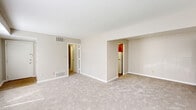 Located at 5303 Rue De Ville in Indianapolis, Indiana, this single-floor, one-bedroom, one-bathroom residence offers a practical and comfortable layout. The living room is the largest area of the home, featuring neutral beige carpeting, warm taupe walls, and two windows that allow natural light to fill the space. A recessed nook with rich cherry-toned cabinetry adds a functional design detail to the room.

The kitchen is equipped with warm honey-toned wood cabinetry featuring decorative raised paneling and ornate hardware, paired with light tile countertops that provide ample workspace. A full-size refrigerator rounds out the functional kitchen layout.

The bedroom offers a comfortable footprint with soft carpeting, a natural light source via a window with blinds, and notable closet storage. Wide louvered bi-fold closet doors span a generous portion of the wall, providing excellent organizational capacity.

The bathroom features a full tub-shower combination with white subway tile surround, chrome fixtures, and classic blue accent tile detailing — a clean, timeless aesthetic. Neutral tones and straightforward finishes carry throughout the home, creating a cohesive and move-in-ready environment ideal for those seeking a manageable, low-maintenance residence in Indianapolis.