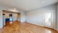 Located at 485 S 44th St W in Billings, Montana, this well-appointed 1-bedroom, 1-bathroom unit offers a thoughtfully designed single-floor layout with a clean, contemporary aesthetic throughout. Light-toned hardwood flooring flows through the main living areas, complementing the soft neutral wall tones and recessed lighting that create a bright, welcoming atmosphere.

The open-concept living, dining, and kitchen area forms the heart of the unit. Large windows allow natural light to fill the space generously. The kitchen is a standout feature, boasting rich dark-espresso cabinetry, white countertops, a subway tile backsplash, and a full suite of stainless steel appliances including a refrigerator, range, microwave, and sink. Ample cabinet and counter space make it highly functional.

A well-lit hallway connects the living area to the bedroom and bathroom. The bedroom offers plush carpeting, a window with exterior views, and access to two closets, providing excellent storage. The bathroom features matching dark cabinetry with white countertops, consistent with the overall design language.

The unit also includes a private balcony accessible from the living area, offering open views of the surrounding neighborhood under Montana's expansive skies — a pleasant outdoor extension of the living space.