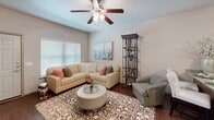 Located at 303 SE Ranger in Bentonville, Arkansas, this one-bedroom, one-bathroom residence offers a thoughtfully designed single-floor layout that maximizes every square foot. The open-concept living area features rich hardwood-style flooring, neutral tones, and a ceiling fan with light kit, creating a bright and comfortable atmosphere. Large windows allow natural light to fill the space, enhancing the airy feel throughout.

The kitchen is a standout feature, equipped with rich dark wood cabinetry, granite countertops, a full suite of stainless steel appliances including a refrigerator, range, microwave, and dishwasher, and a breakfast bar that provides additional dining and prep space. Hardwood-style flooring continues seamlessly from the kitchen into the living area.

The bedroom is a well-sized, carpeted retreat with a ceiling fan, a large window offering natural light, and a dedicated closet for storage. The full bathroom is finished with warm wood-toned cabinetry, a granite-topped vanity, framed mirror with a lighted vanity bar, and tile-style flooring. A washer and dryer hookup is also visible within the unit, adding everyday convenience to this efficiently designed Bentonville home.