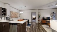 Located at 216 Rutledge Spur in Austin, TX 78717, this well-designed single-story apartment offers 960 square feet of living space across 2 bedrooms and 3 bathrooms. Wood-style plank flooring flows throughout the main living areas, adding a cohesive, modern aesthetic.

The living room is bright and inviting, featuring crown molding, a ceiling fan, and a sliding glass door that brings in natural light. Adjacent to it, the dining area accommodates a full-sized table beneath a contemporary overhead fixture and connects seamlessly to the kitchen. The kitchen is outfitted with dark espresso cabinetry, stainless steel appliances including a range and microwave, a mosaic tile backsplash, and white countertops.

The primary bedroom spans 190 square feet and includes a ceiling fan, carpet flooring, and a generously sized window. Both bedrooms offer comfortable proportions with ample closet space. The three bathrooms feature dark espresso vanities with white countertops and wood-style tile flooring; one includes a tub-shower combo with stylish tile surround.

A dedicated in-unit laundry room with side-by-side washer and dryer and built-in shelving adds everyday convenience. Two closets and a hallway complete the functional layout of this thoughtfully appointed Austin apartment.