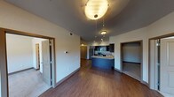 Located at 3425 S Shields St in Fort Collins, Colorado, this single-floor unit offers a thoughtfully designed layout that balances functionality and comfort. The open-concept living and dining area features rich hardwood-style flooring, ceiling fans, and a sliding glass door that opens to a private balcony, allowing natural light to fill the space and providing outdoor views.

The kitchen is a standout feature, equipped with dark espresso cabinetry, stainless steel appliances including a refrigerator, electric range, and microwave, as well as granite countertops and a peninsula that enhances both workspace and casual dining options. Recessed lighting adds a polished touch to the kitchen area.

The bedrooms are carpeted for comfort, each featuring ceiling fans and windows that bring in natural light. One bedroom includes a built-in shelving nook, adding practical storage. The bathrooms are well-finished, with one featuring a tiled tub-shower combination, granite-topped vanity, and large format tile flooring. A shared hallway bathroom includes a dark-cabinetry vanity with granite countertops, offering additional convenience.

Throughout the unit, neutral tones, dark wood trim, and consistent finishes create a cohesive and modern aesthetic suitable for everyday living in Fort Collins.