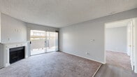 Located at 619 E Riverside Dr in Ontario, CA, this single-floor, one-bedroom, one-bathroom unit offers a practical and well-organized layout across a comfortable footprint. The living room serves as the heart of the space, featuring a fireplace as a standout focal point, soft wall-to-wall carpeting, and a sliding glass door that opens to an outdoor area while filling the room with natural light. Neutral gray walls and a textured ceiling carry throughout, lending the space a cohesive, understated tone. The galley-style kitchen is efficiently designed, outfitted with white cabinetry, light stone-toned countertops, a stainless steel sink, a gas range, and a refrigerator, all set on light wood-look flooring. A peninsula counter connects the kitchen to the adjacent dining area, which also features a ceiling fan. The spacious primary bedroom is carpeted and includes a closet, windows for natural light, and ample room for furnishings. The bathroom features light wood-look flooring, a white vanity with stone-toned countertop, a large mirror, and overhead lighting. Throughout the unit, clean white trim, neutral walls, and consistent flooring choices create a calm, move-in-ready atmosphere.