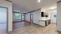 Located at 1200 Reserve Drive Northeast in Atlanta, GA, this two-bedroom, two-bathroom residence offers a well-designed, single-level layout filled with modern finishes and functional living spaces. Light-toned hardwood-style flooring runs throughout, lending a clean, cohesive look to every room.

The open-concept living and kitchen area forms the heart of the home. The kitchen features dark cabinetry, stainless steel appliances including a range, microwave, and refrigerator, and a peninsula with a white countertop and sink that flows naturally into the living room. The living area is bright and spacious, anchored by a ceiling fan and French doors with large windows that provide ample natural light and direct access to an outdoor balcony.

The primary bedroom is generously sized, highlighted by crown molding, a ceiling fan, and French door access to the balcony. It includes a walk-in closet with wire shelving for organized storage. The second bedroom offers natural light through a large window and its own ceiling fan. Both bathrooms are cleanly appointed, with one featuring a full tub-shower combination with tiled surround.

Additional highlights include two closets, dark wood crown molding accents, and a dedicated in-unit laundry space equipped with a full-size washer. The overall ambiance is modern, bright, and move-in ready.
