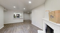 Located at 16550 Henderson Pass in San Antonio, TX, this single-story home offers three bedrooms, three bathrooms, and a thoughtfully organized layout across one floor. The open living and dining area is anchored by a white brick fireplace and features wood-look luxury vinyl flooring throughout, recessed lighting, and a sliding glass door that opens to a private patio. The kitchen is designed with functionality in mind, featuring a pass-through window with a marble-look countertop breakfast bar, white cabinetry, matching marble-look countertops, and black appliances including a refrigerator, range, and microwave. A dedicated laundry area adds everyday convenience. Each of the three bedrooms is carpeted and equipped with a ceiling fan. The primary bedroom includes an en-suite bathroom and offers a comfortable, well-proportioned retreat. The additional bedrooms each include closets with built-in hanging rods. All three bathrooms are finished with white vanities, marble-look countertops, and tub-shower combinations with tiled surrounds. Four closets throughout the home provide ample storage. The neutral gray-and-white color palette creates a clean, cohesive aesthetic throughout the entire space.