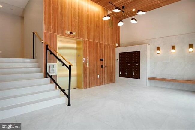 Modern lobby with secure package room. - 801 N St NW