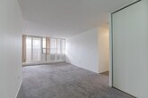 Located at 1900 Bloor St E in Mississauga, this well-appointed 3-bedroom, 3-bathroom unit offers a generous and functional layout across a single floor. The kitchen features white cabinetry with dark countertops, tile backsplash, tile flooring, and white appliances including an electric range. Its open-facing design connects seamlessly to the carpeted living area, creating an easy flow throughout the main living spaces. The bedrooms are bright and comfortable, with classic parquet wood flooring and large windows fitted with vertical blinds that allow plenty of natural light to filter in. The primary bedroom is notably spacious, offering room for a full furniture arrangement and convenient access to an ensuite bathroom. Each of the three bathrooms is distinctly appointed — one features a decorative oval mirror with elegant vanity lighting above white cabinetry, another offers a bold patterned mirror frame with a marble-style countertop, and a third presents a clean, minimalist design with mosaic tile flooring. A private balcony extends the living space outdoors. Throughout the unit, neutral tones and clean finishes create a bright, move-in-ready environment suitable for a variety of lifestyles.
