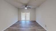 This contemporary 900 square foot apartment in Charlotte, NC offers a harmonious blend of comfort and style. The space features two bedrooms, including a primary bedroom of 160 square feet, and two full bathrooms. The open-concept layout seamlessly integrates the kitchen and living areas, creating an ideal environment for both relaxation and entertainment.

The kitchen is a highlight, boasting modern white cabinetry contrasted with dark lower cabinets, stainless steel appliances, and elegant granite countertops. Pendant lighting adds a touch of sophistication, while the center island provides additional workspace and casual dining options.

Throughout the apartment, wood-look flooring lends warmth and durability. Bedrooms are equipped with ceiling fans and mini-split air conditioning units for personalized climate control. The bathrooms feature clean lines with white fixtures and ample storage.

Additional amenities include an in-unit laundry room with full-sized appliances, ensuring convenience for residents. The living room is bathed in natural light from French doors leading to an outdoor space, perfect for enjoying morning coffee or evening relaxation.

With its thoughtful design and modern finishes, this apartment offers a turnkey living solution in the heart of Charlotte, combining urban accessibility with home comfort.