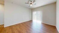 Located at Lakeshore in Port Arthur, TX, this well-appointed 1-bedroom, 1-bathroom unit offers a thoughtfully designed single-floor layout. The open living area is a standout, featuring warm wood-look flooring that runs throughout the entire unit, crisp white walls, and a stylish ceiling fan with integrated lighting. A large sliding glass door dressed with vertical blinds floods the space with natural light and provides outdoor access, enhancing the sense of openness.

The kitchen is efficiently designed with white shaker-style cabinetry accented by gold-toned hardware, a patterned geometric tile backsplash, light quartz countertops, a stainless steel sink, and full-size appliances including a refrigerator and dishwasher. The space flows seamlessly from the kitchen into the living area.

The bedroom is a comfortable, well-lit room with the same consistent wood-look flooring, a ceiling fan, and a closet for storage. The full bathroom features a tiled tub/shower surround with elongated white tile, a single vanity with a white countertop, gold hardware accents, and a large mirror.

A dedicated in-unit laundry room houses a full-size front-loading washer and dryer, adding exceptional convenience to daily living.