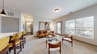 Located at 5866 War Admiral Ln in Grove City, Ohio, this one-bedroom, one-bathroom unit offers a thoughtfully designed single-floor layout with a bright, welcoming ambiance throughout. The open-concept living and kitchen area serves as the heart of the home, with plush carpeting in the living space and warm wood-look flooring in the kitchen. Large windows with blinds flood the area with natural light, while a glass door leads to a private balcony with outdoor views. The kitchen is outfitted with crisp white cabinetry featuring black hardware, stainless steel appliances including a range, microwave, and dishwasher, and clean light countertops. A dedicated pantry provides additional storage. The generously sized bedroom features carpet flooring, multiple windows that invite natural light, and access to two closets offering ample storage with built-in wire shelving. The bathroom includes wood-look flooring, a white vanity with a framed mirror, and a clean, modern aesthetic. Additional highlights include a dedicated laundry area and a utility room, making this a fully functional and comfortable living space with practical amenities throughout.