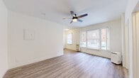 Located on Franklin Avenue in the heart of Hollywood, Los Angeles, this efficiently designed studio unit offers a well-organized single-floor layout that maximizes every square foot. The main living area is bright and airy, featuring light-toned hardwood-style flooring, crisp white walls, and a ceiling fan with integrated lighting. Multiple windows allow natural light to fill the space and provide views of the surrounding neighborhood streetscape. A wall-mounted heating unit ensures year-round comfort.

The galley-style kitchen is thoughtfully appointed with warm wood cabinetry, granite-look countertops, a stainless steel refrigerator, a gas range, and a double-basin sink — offering a complete cooking setup within a compact footprint.

The bathroom presents a clean, modern aesthetic with a white vanity, a round black-framed mirror, and wood-look flooring that carries through from the main living area. The walk-in closet features overhead shelving and hanging rods, providing practical storage solutions.

The entrance leads seamlessly into the open living space, creating a cohesive and functional flow throughout the unit. The overall design palette of whites, warm wood tones, and neutral finishes gives the studio a fresh, move-in-ready ambiance ideal for urban living in one of Los Angeles' most vibrant neighborhoods.